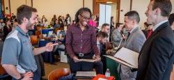 Picture of a student speaking with a prospective employer at a career fair.