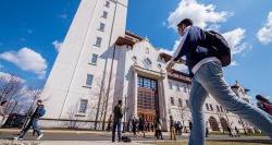 Students walking on campus in front of University Hall.